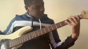 Tyrique jamming along to Your Great Name by Todd Dulaney on the bass
